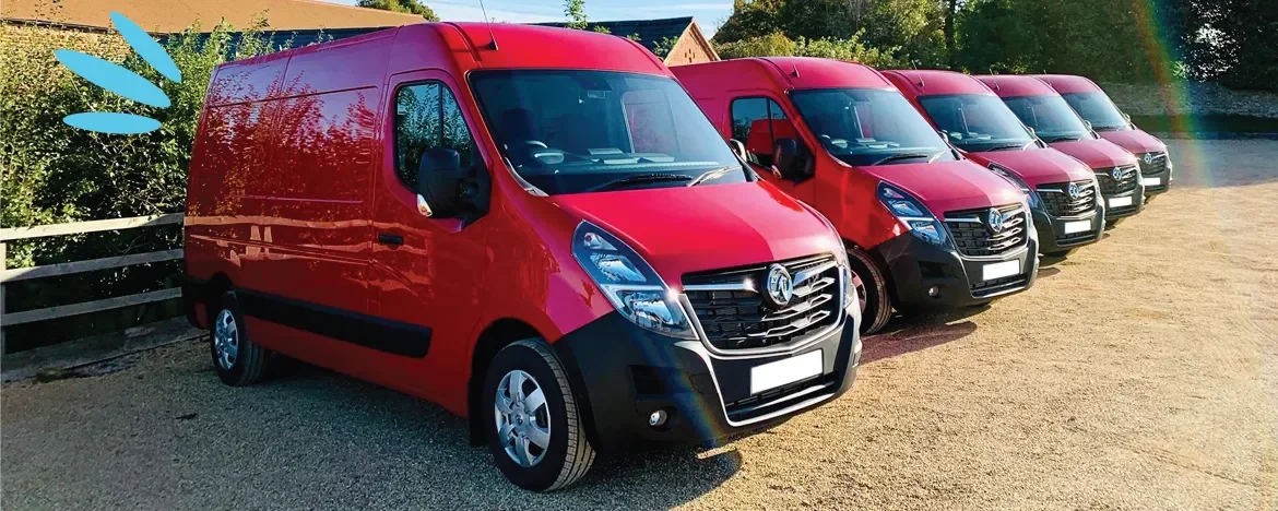 Line up of red Vauxhall Movano vans