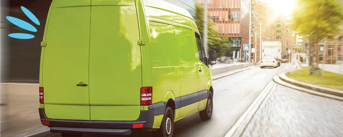 Green van driving through town